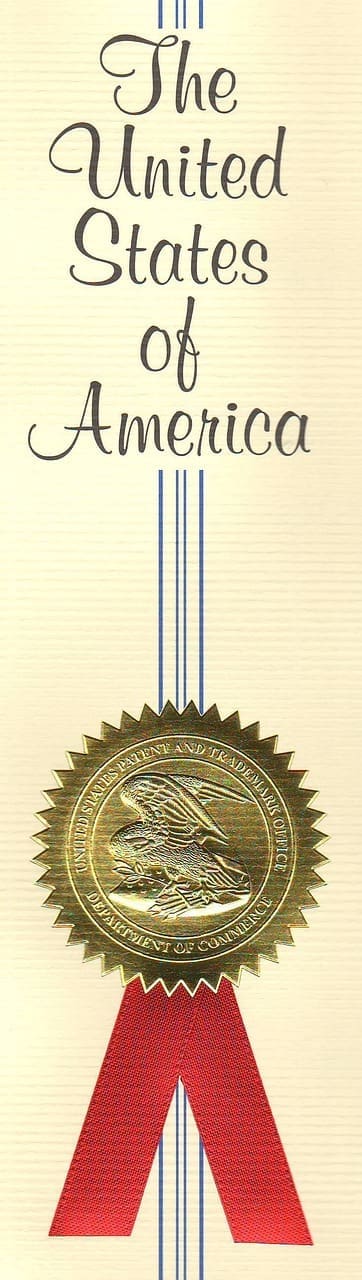 The gold seal of the United States Patent and Trademark Office on a printed certificate, relevant to patent and trademark filings from Glens Falls, New York