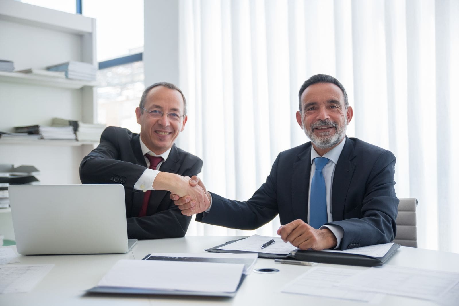 Attorney and client shaking hands after reaching an agreement