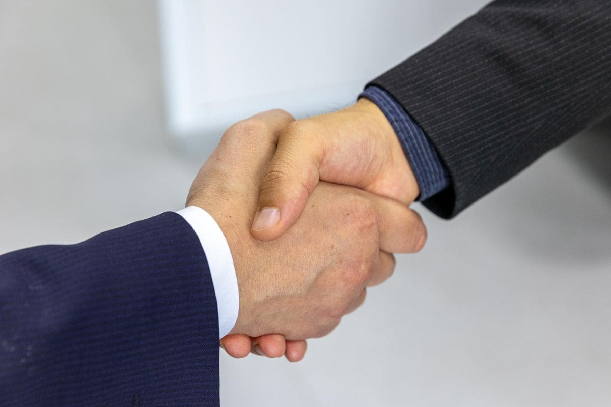 An attorney shakes hands with a client after a legal consultation