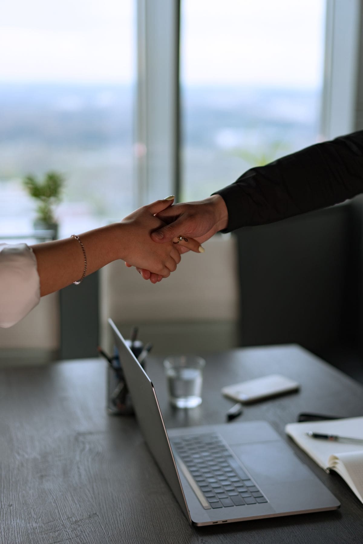 An attorney shakes hands with a client after a legal consultation