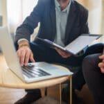 An attorney reviews documents with clients during a consultation