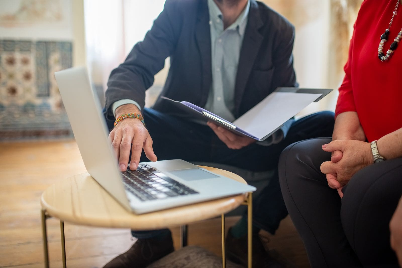 An attorney reviews documents with clients during a consultation