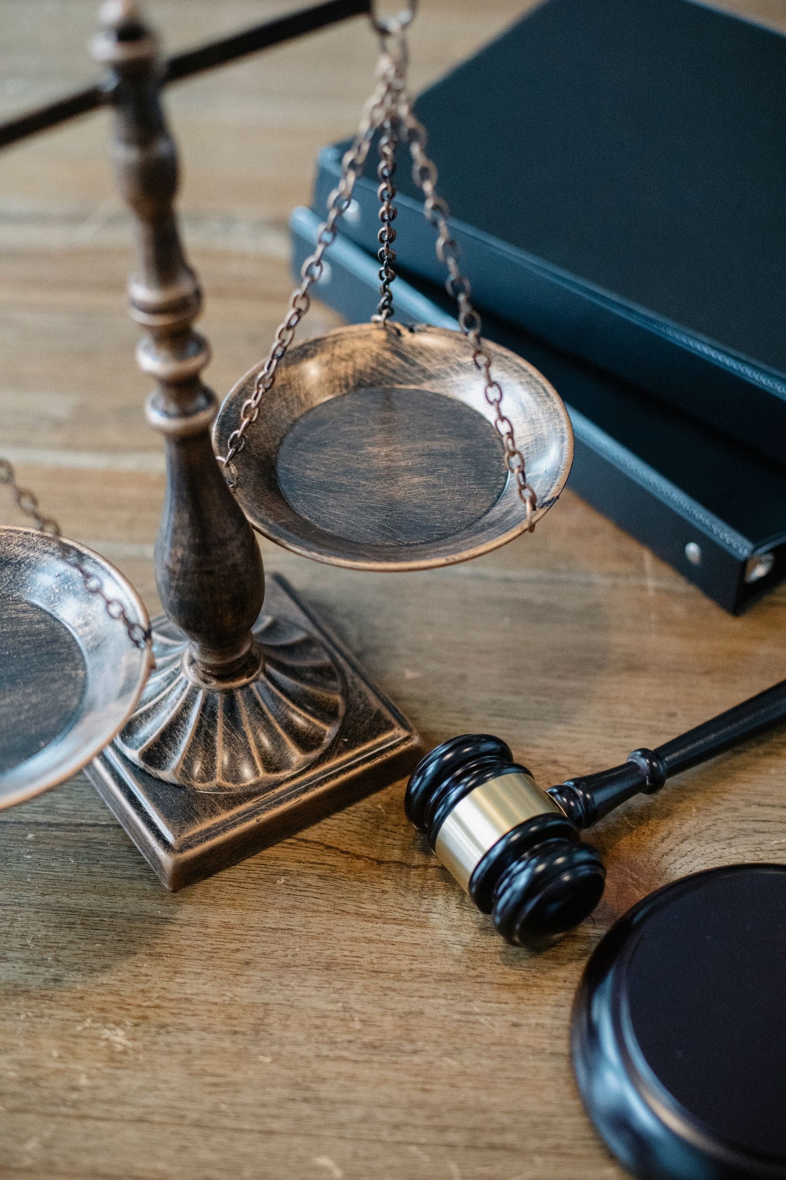 Scales of justice and a gavel on a wooden table
