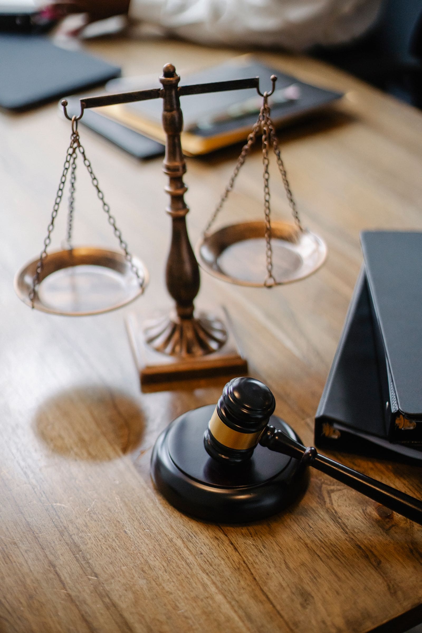 Scales of justice and a gavel on a wooden desk
