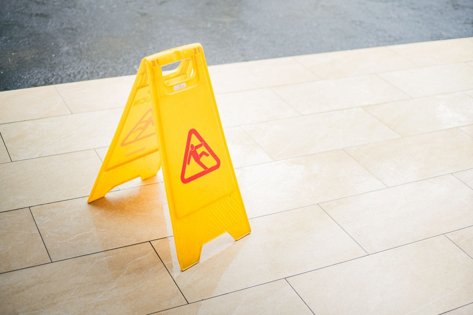 A yellow wet floor caution sign on a tile floor, the kind of hazard behind slip and fall claims in Lebanon, Pennsylvania